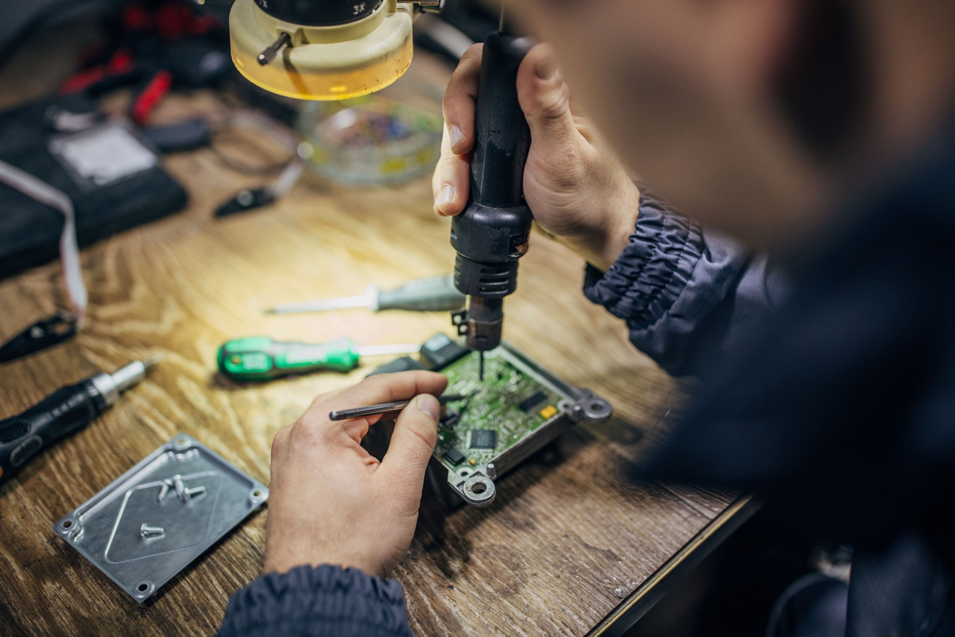 Man repairing car computer part