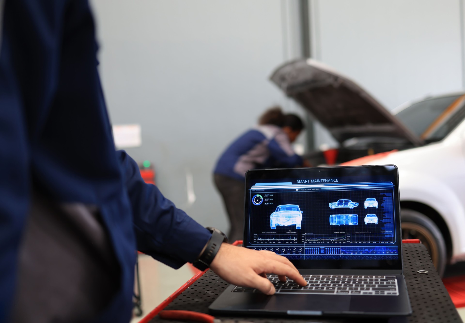 Mechanical engineer check and maintenance, smart maintenance system in modern car garage. Auto mechanic work with smart software maintenance vehicle